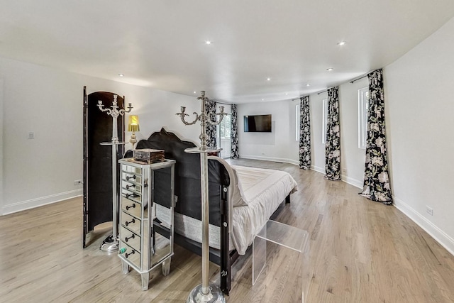 bedroom with light wood finished floors, recessed lighting, and baseboards