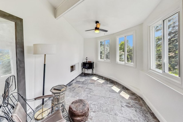 sunroom featuring a wealth of natural light, vaulted ceiling with beams, and a ceiling fan