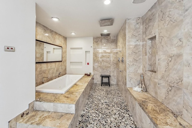 full bathroom featuring a garden tub, recessed lighting, tile walls, and a tile shower