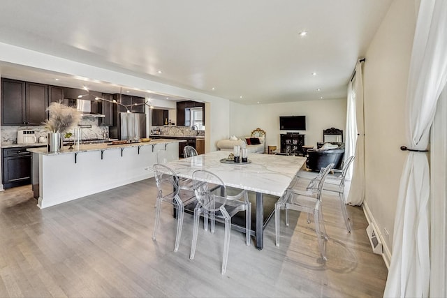 dining space featuring recessed lighting and light wood-type flooring