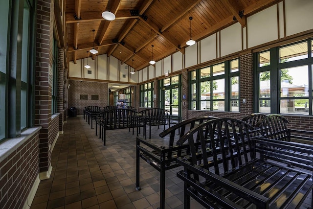 interior space featuring wooden ceiling and lofted ceiling with beams