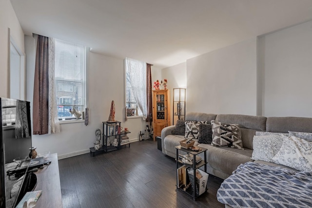 living area featuring dark wood-type flooring and baseboards