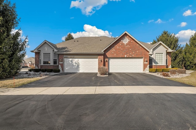 ranch-style home featuring brick siding, an attached garage, aphalt driveway, and roof with shingles