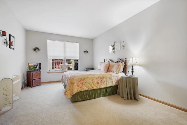 bedroom with baseboards and carpet floors