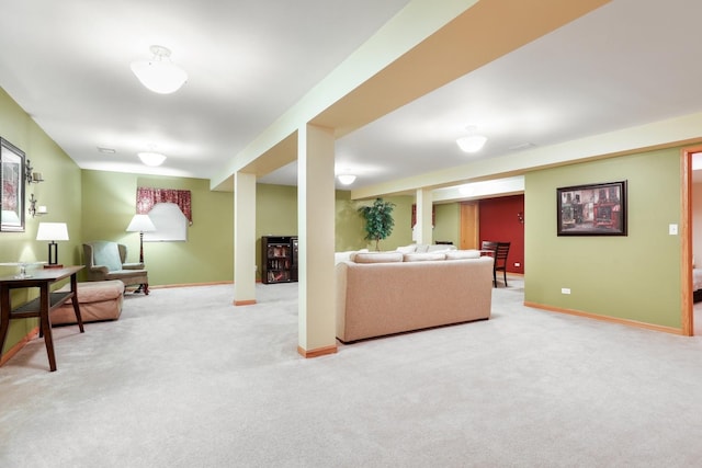 living area with light colored carpet and baseboards