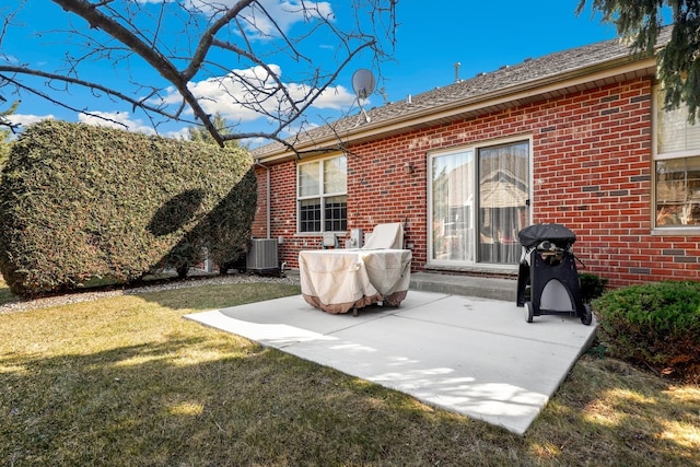 back of house with cooling unit, a patio, a lawn, and brick siding