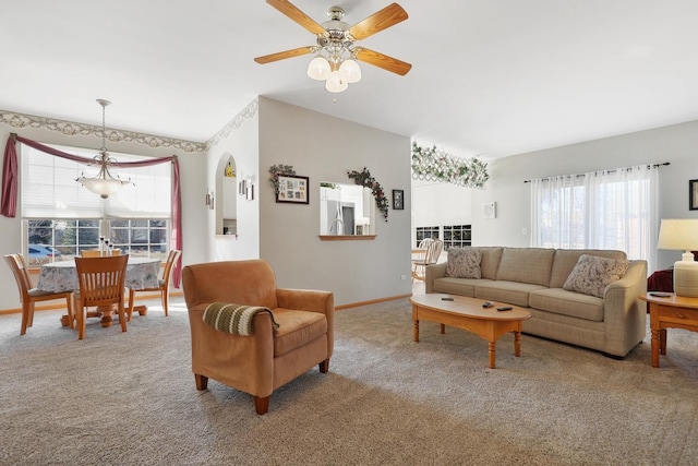 living room with a ceiling fan, carpet, and baseboards