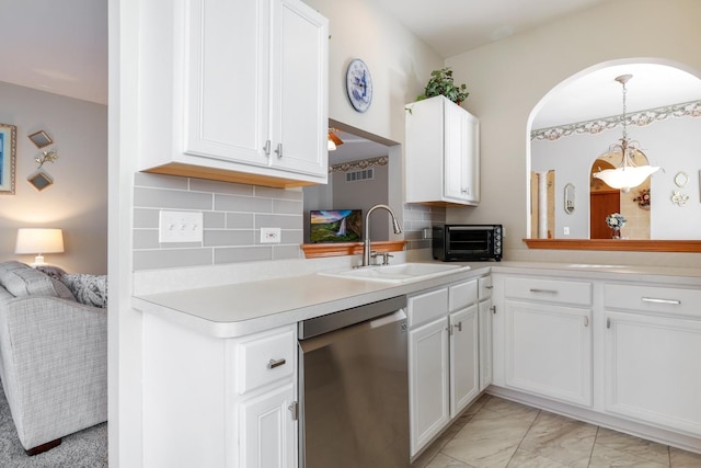 kitchen featuring white cabinetry, a toaster, a sink, light countertops, and stainless steel dishwasher