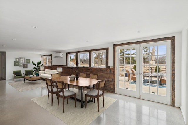 41660 N Hunt Club Rd, Old Mill Creek, IL 60083 - dining area featuring a wall mounted AC, a wealth of natural light, french doors, and concrete floors