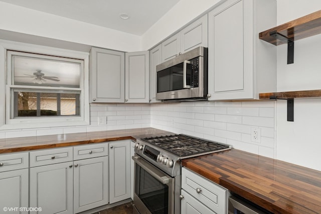 41660 N Hunt Club Rd, Old Mill Creek, IL 60083 - kitchen featuring decorative backsplash, wood counters, a ceiling fan, and appliances with stainless steel finishes