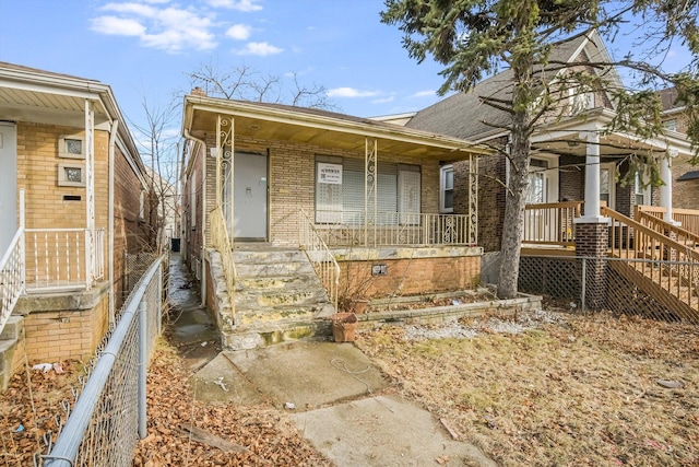 view of front of home featuring brick siding and covered porch