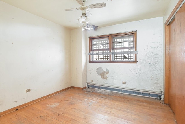 unfurnished room featuring baseboards, wood-type flooring, and ceiling fan