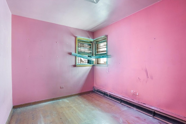 empty room with baseboards and wood finished floors