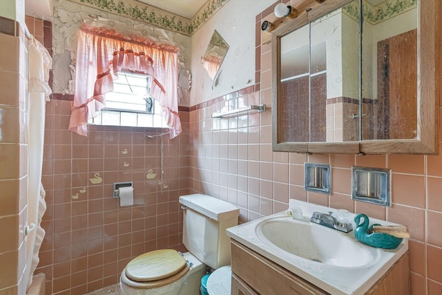 bathroom with vanity, tile walls, and toilet