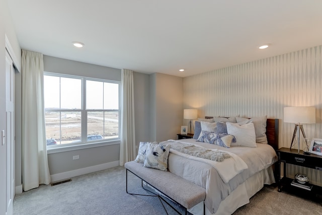 carpeted bedroom with recessed lighting, visible vents, and baseboards