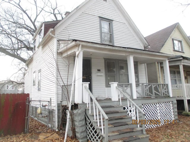 view of front facade with a porch and fence