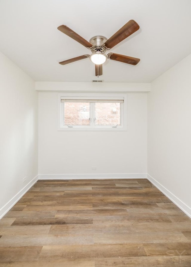 spare room with visible vents, baseboards, and light wood-style floors