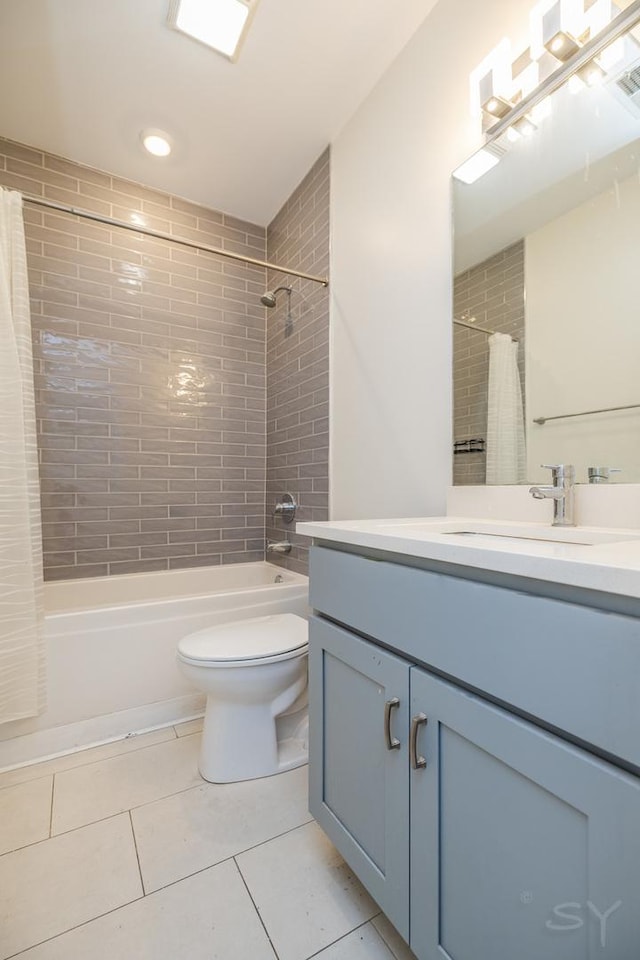 bathroom with shower / bathtub combination with curtain, toilet, vanity, and tile patterned flooring