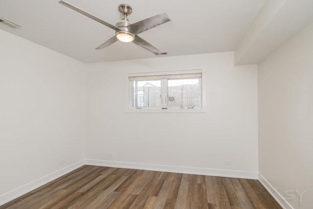 unfurnished room with visible vents, wood finished floors, baseboards, and ceiling fan