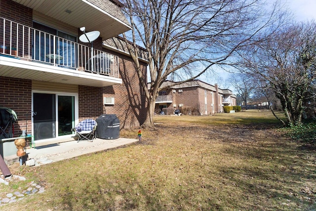 view of yard featuring a patio and a balcony