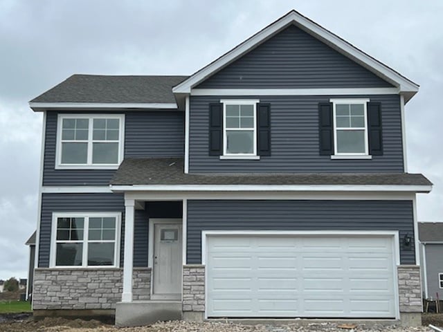 view of front of property with stone siding and an attached garage