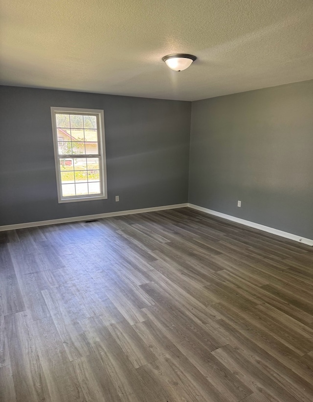 1312 N Hickory St, Champaign, IL 61820 - spare room featuring dark wood finished floors and a textured ceiling