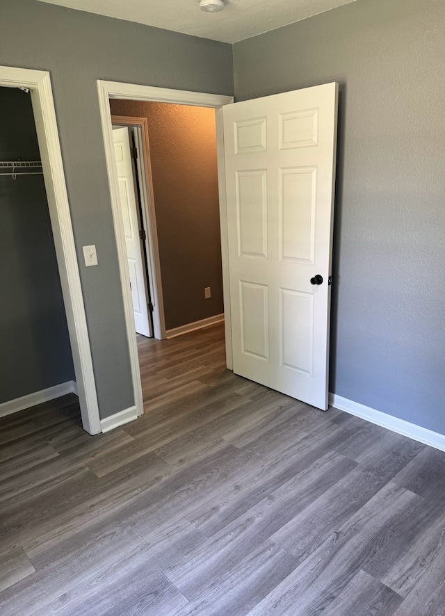 1312 N Hickory St, Champaign, IL 61820 - unfurnished bedroom featuring wood finished floors and a closet