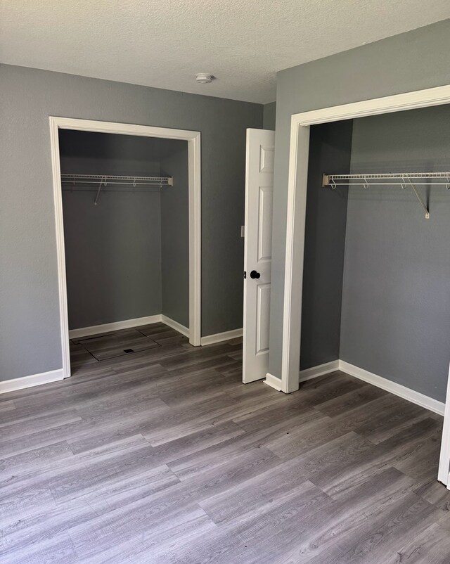 1312 N Hickory St, Champaign, IL 61820 - unfurnished bedroom featuring a closet, wood finished floors, and a textured ceiling