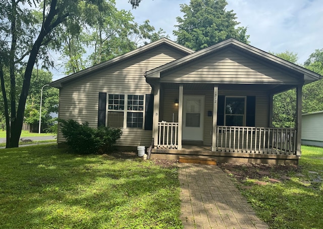 1312 N Hickory St, Champaign, IL 61820 - bungalow-style home with a porch and a front yard