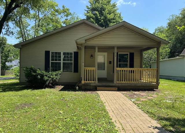 1312 N Hickory St, Champaign, IL 61820 - bungalow-style home with a front yard and covered porch