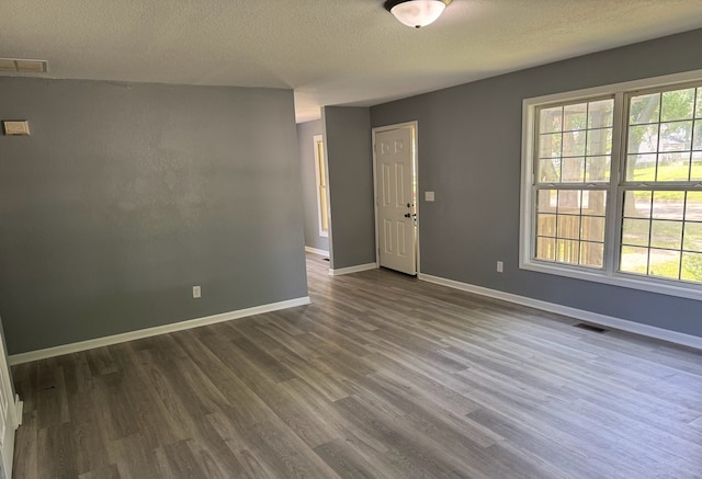 1312 N Hickory St, Champaign, IL 61820 - spare room with dark wood finished floors and a textured ceiling
