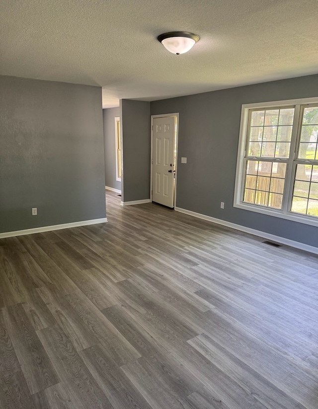 1312 N Hickory St, Champaign, IL 61820 - empty room featuring a textured ceiling and dark wood-type flooring