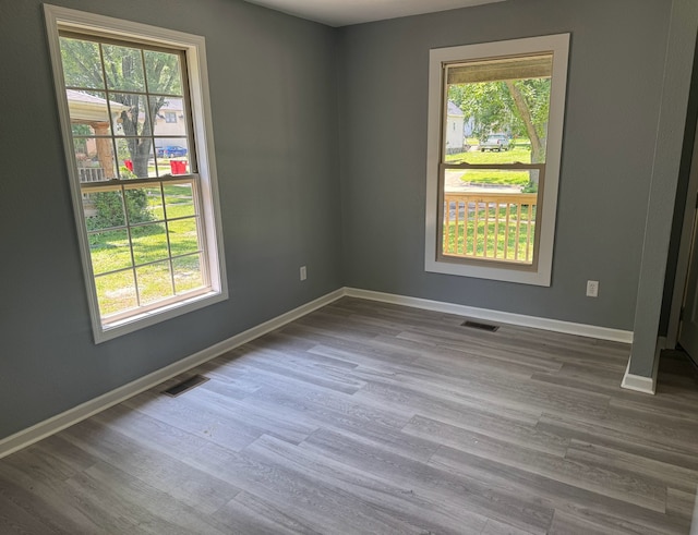 1312 N Hickory St, Champaign, IL 61820 - empty room with healthy amount of natural light and dark wood finished floors