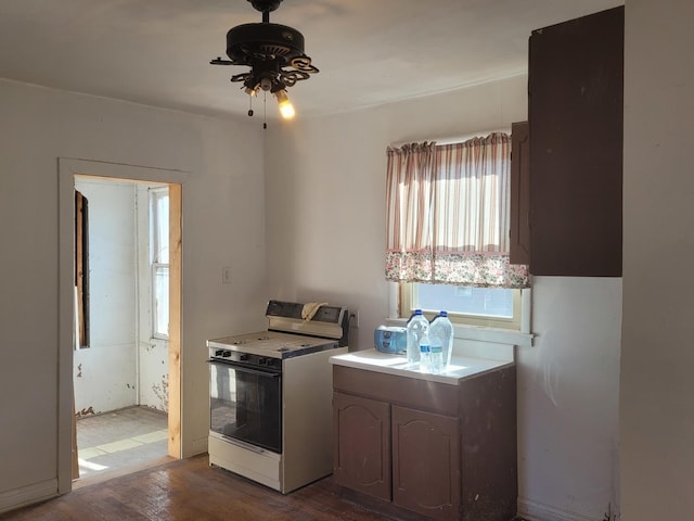 kitchen with ceiling fan, light countertops, electric range oven, and wood finished floors