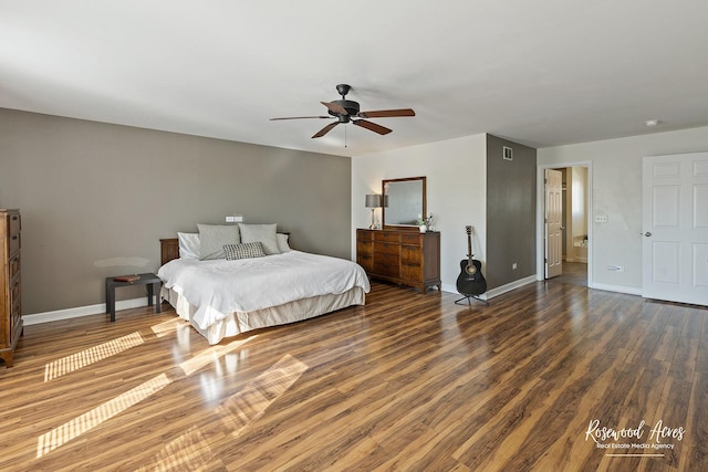 bedroom with visible vents, wood finished floors, baseboards, and ceiling fan