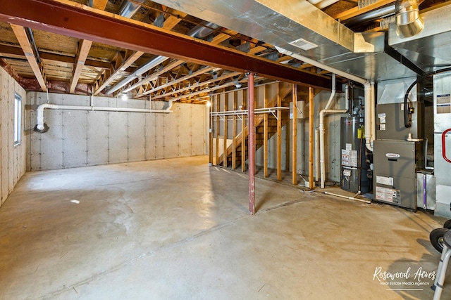 unfinished basement featuring heating unit and gas water heater