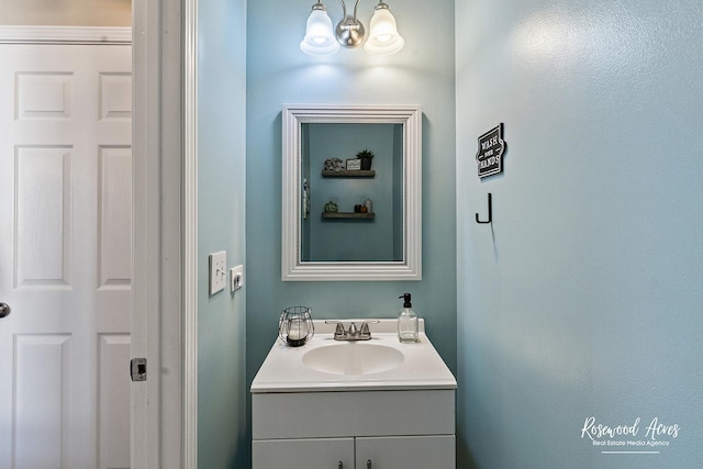 bathroom featuring an inviting chandelier and vanity