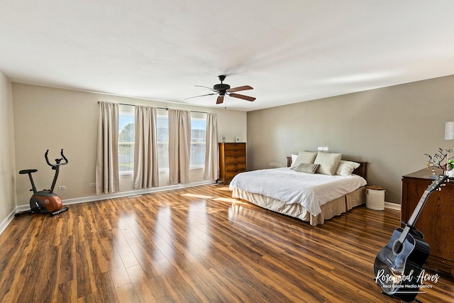 bedroom featuring a ceiling fan, baseboards, and wood finished floors