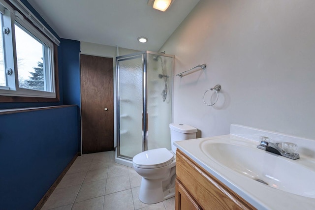 full bathroom featuring vanity, tile patterned floors, toilet, and a stall shower