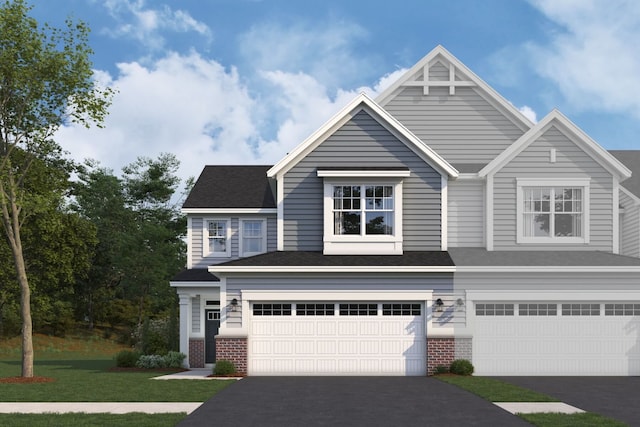 view of front of property with aphalt driveway, a front lawn, brick siding, and an attached garage