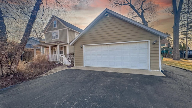 view of front of property featuring a garage and a porch