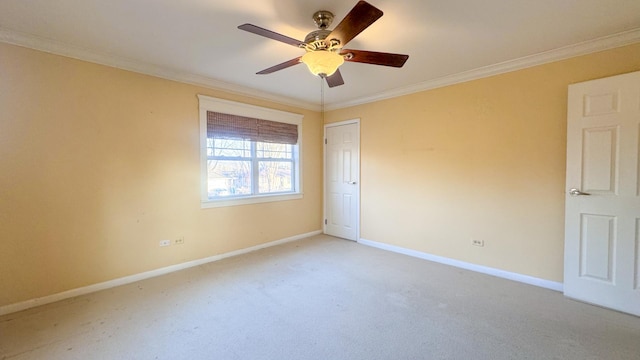 spare room featuring light carpet, baseboards, and ornamental molding