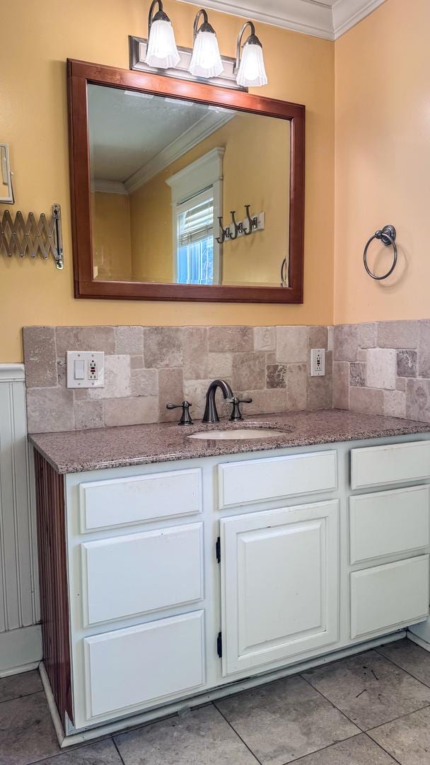 bathroom with vanity and ornamental molding