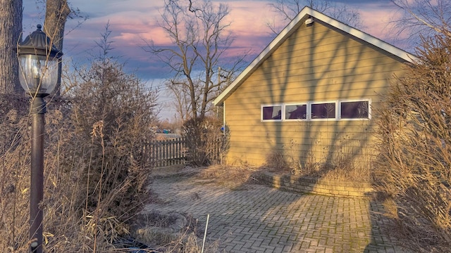 view of side of property featuring a patio area and fence