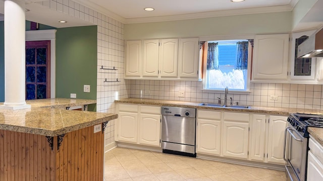 kitchen featuring crown molding, stainless steel appliances, white cabinetry, wall chimney exhaust hood, and a sink