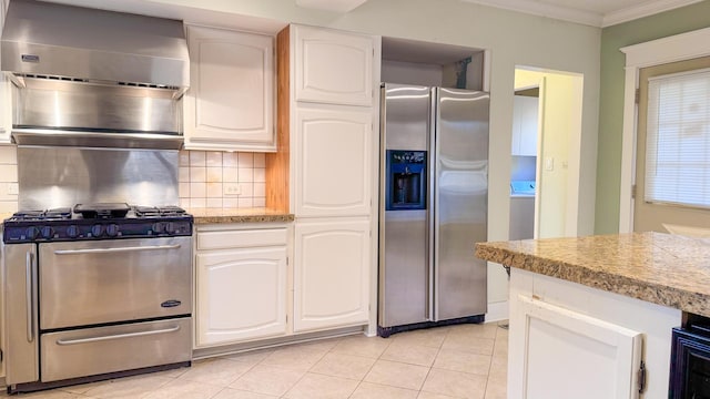 kitchen featuring decorative backsplash, white cabinetry, and appliances with stainless steel finishes