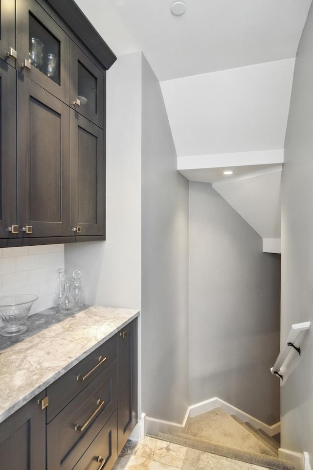 bar featuring tasteful backsplash and baseboards