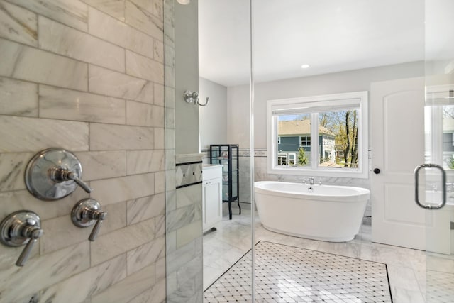 bathroom with a soaking tub, a shower stall, and tile walls