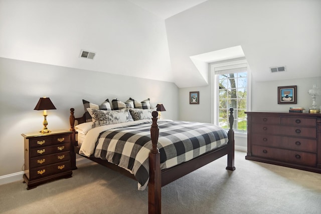 carpeted bedroom featuring visible vents and vaulted ceiling