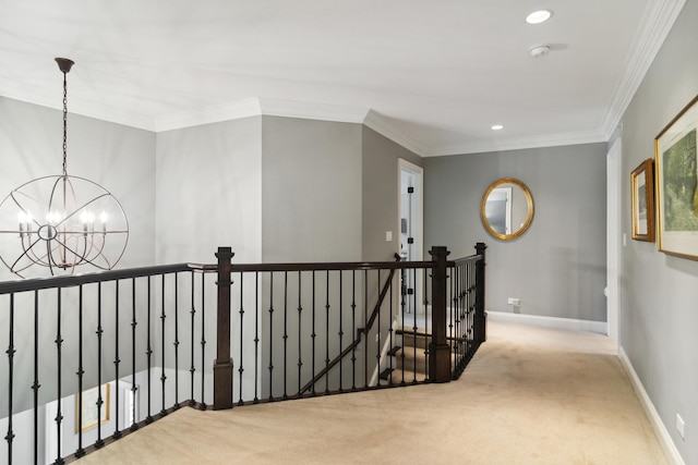 hallway featuring an upstairs landing, carpet floors, and ornamental molding